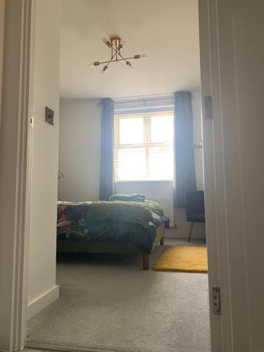 a bedroom with a bed and a ceiling fan at Peterborough City Center One Bed apartment With Free Private Parking in Peterborough