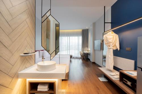 a bathroom with a white sink in a room at Centara Life Hotel Bangkok Phra Nakhon in Bangkok