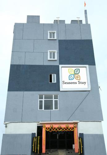 a building with a sign on the side of it at Seasons Stay in Vijayawāda
