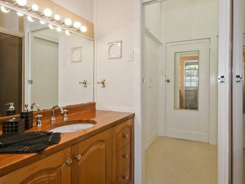 a bathroom with a sink and a large mirror at York Cottage. A Country Retreat in Burradoo. in Burradoo