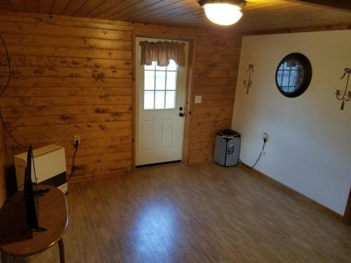 an empty room with a white door and a window at CAPE CODE BEAUTY IN THE APPALACHIANS in Piney Creek