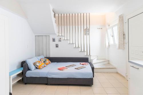 1 dormitorio con 1 cama y escalera en Sunrise en Kardamaina