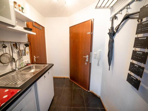 a kitchen with a sink and an umbrella on the wall at Chilly Studio - Super Central in Mannheim