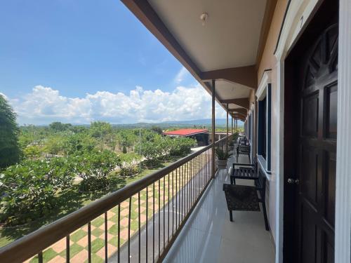 a balcony of a house with a view of the countryside at La Plumerias in Moalboal