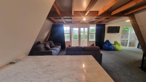 a living room with a couch and a table at 47 Woodbank Road in Hanmer Springs