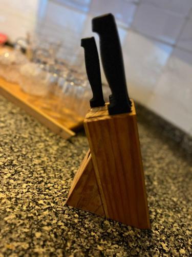 a wooden knife block sitting on the floor at Centaurus Two Bedroom Apartment in Islamabad