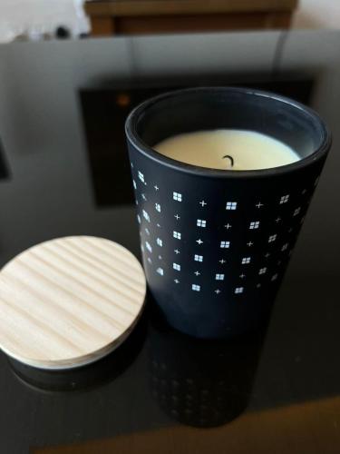 a cup of coffee and a candle on a table at Centaurus Two Bedroom Apartment in Islamabad