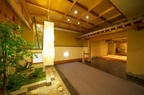 a living room with a light in the center of a building at Hodakaso Yamano Hotel in Takayama