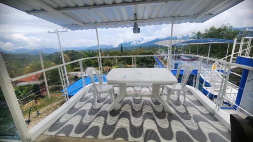 a table and chairs on the deck of a boat at Hotel spa la buena vida in Fusagasuga