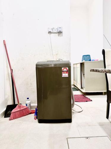 a green refrigerator sitting on the floor in a room at Isyfaq Homestay 2 bedroom & 2 bathroom in Kota Tinggi