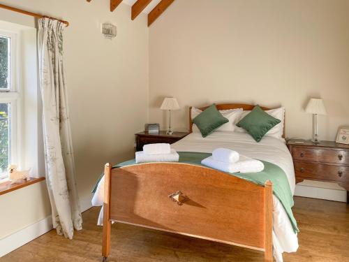 a bedroom with a bed with two towels on it at The Beaches in Stalham