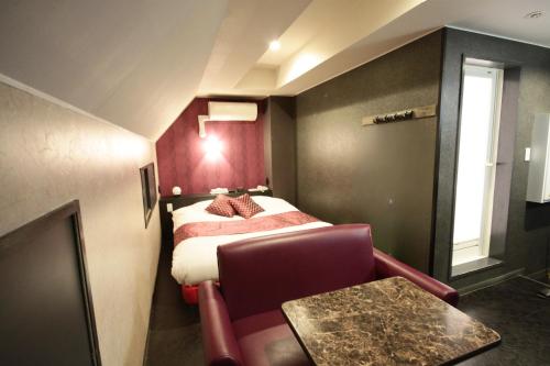 Postel nebo postele na pokoji v ubytování Hotel RIO新宿
