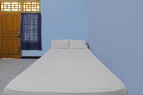 1 cama con 2 almohadas en una habitación en SPOT ON 92567 Jati Homestay, en Lombok
