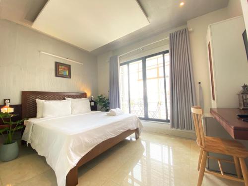 Giường trong phòng chung tại Gemini Saigon APARTMENT