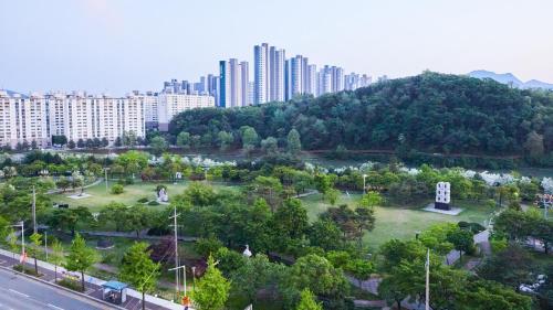 an aerial view of a park in a city with tall buildings at Chuncheon Eston Hotel in Chuncheon