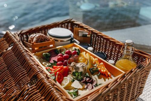 a wicker basket with food in it on a table at HT Houseboats - domki na wodzie - sauna, motorówka, rowerki wodne in Mielno