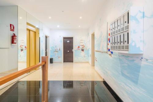 a hallway in a building with a mural on the wall at Piso en Ribeira, primera línea. in Ribeira