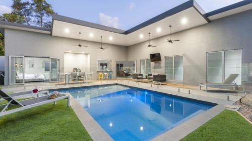 a large swimming pool in a house at Kokomo Port Douglas in Port Douglas
