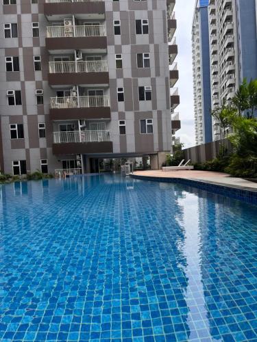 a large swimming pool in front of a building at Apartment Podomoro Medan in Medan