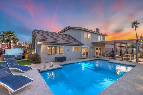 a swimming pool in the backyard of a house at Sunset Swim, Luxury Vegas Villa with Pool, Hot Tub in Las Vegas