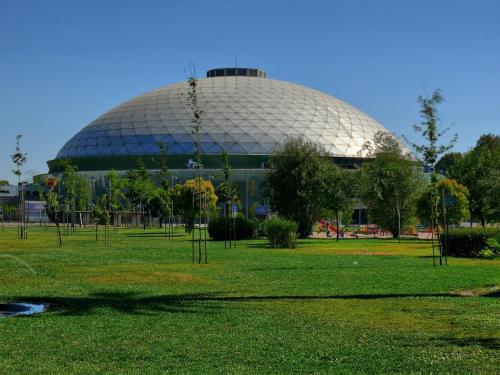 a large building with a dome in the middle of a field at Gran Departamento de tres dormitorios a pasos del metro la Moneda in Santiago