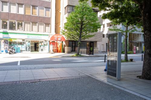 a city street with a sign on the side of the road at Toshi Center Hotel in Tokyo
