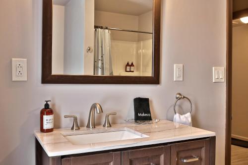 a bathroom with a sink and a mirror at 10 Min to Mountains Long Trail Suite in Bridgewater