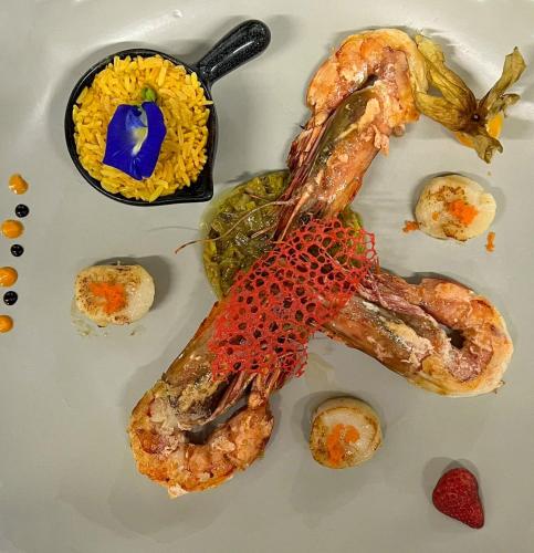 a plate of food with shrimp and rice at Elephant Beach Club & Resort Samui in Chaweng