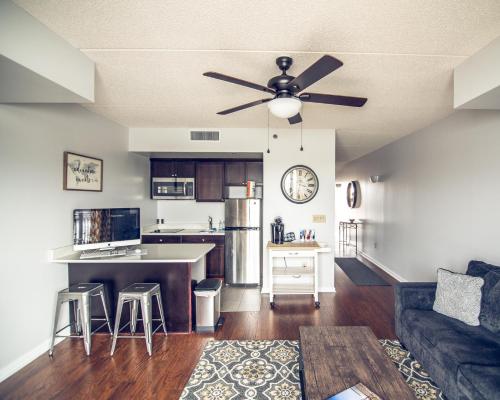 a kitchen and living room with a ceiling fan at Water Street Retreat 14 in Wilmington