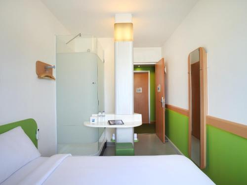 a hospital room with a bed and a sink at Cordia Hotel Surabaya Airport - Hotel Dalam Bandara in Sidoarjo