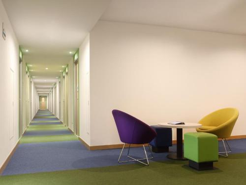 a corridor of an office with chairs and a table at Cordia Hotel Surabaya Airport - Hotel Dalam Bandara in Sidoarjo