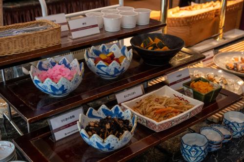 a buffet of different types of food in blue and white bowls at Toshi Center Hotel in Tokyo