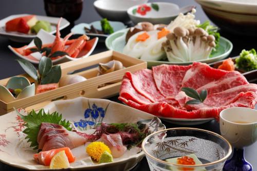 a table with many plates of food on it at Oyado Seri in Toyooka