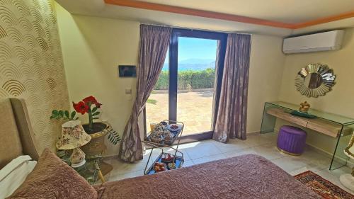 a living room with a large window with a view at Aphrodite View in Korakiaí
