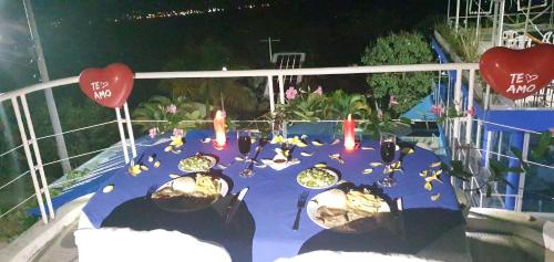 a table on a balcony with a blue table cloth at Hotel spa la buena vida in Fusagasuga