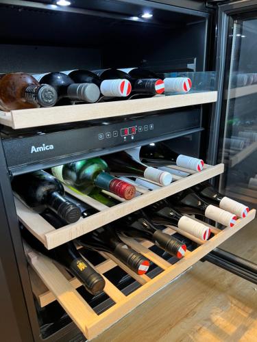 a drawer full of wine bottles in a refrigerator at Ferienhaus auf 7 ha Alleinlage - Pool,Whirlpool, Sauna - Das Refugium Südsteiermark in Lieschen