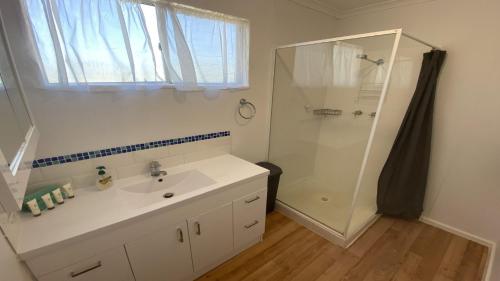 a bathroom with a white sink and a shower at Blue Marlin in Jurien Bay