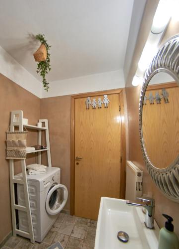 a bathroom with a washing machine and a sink at Iraklitsa View in Iraklitsa