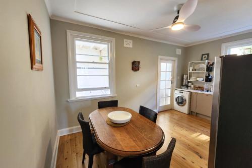 a dining room with a wooden table and chairs at Discover Queenscliff in Sydney