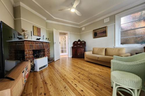 a living room with a couch and a fireplace at Discover Queenscliff in Sydney
