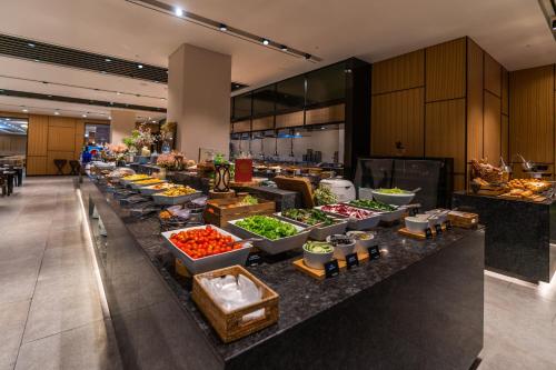 a buffet line with bowls of food on a counter at Sono Moon Danyang in Danyang