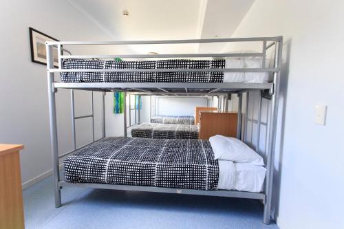 a bedroom with two bunk beds in a room at YHA Cairns Central in Cairns