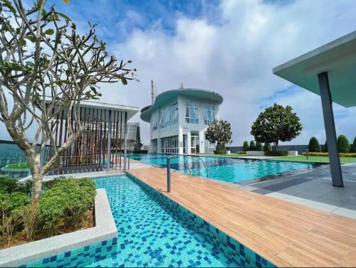 a swimming pool in front of a building at Windmill Upon Hills, Genting Highlands 2 King bed & 2 free car park in Genting Highlands