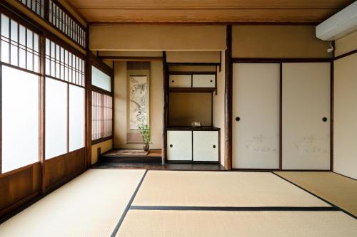 an empty room with doors and windows at Third&Place Kyoto_ShijoOmiya/四条大宮 in Kyoto