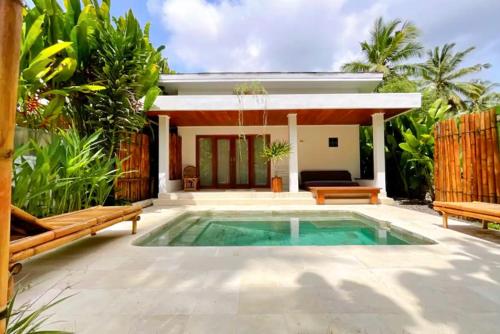 a swimming pool in front of a villa at Private Pool Villa Retreat NAMU no4 no5 no6 in Kuta Lombok
