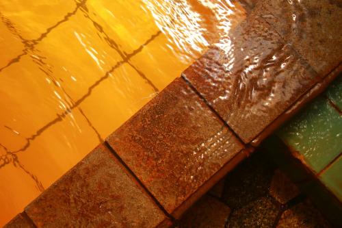 a close up of a tiled floor with water on it at Yumoto Kobayashi in Kurume