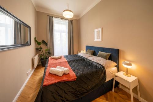 a bedroom with a large bed in a room at Apart Hotel Zborovska in Prague