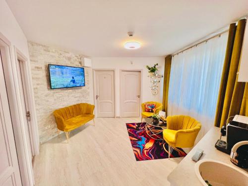 a living room with two chairs and a table at IANIS Rooms in Mangalia