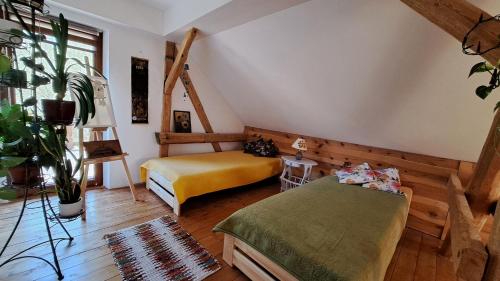 a bedroom with two beds in a attic at Ostoja Leśna Cisza 