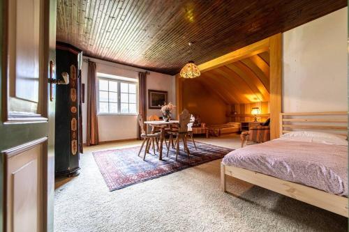 a bedroom with a bed and a table and chairs at [LAGO DI CAREZZA] Dolomiti Vista Mozzafiato in Nova Levante